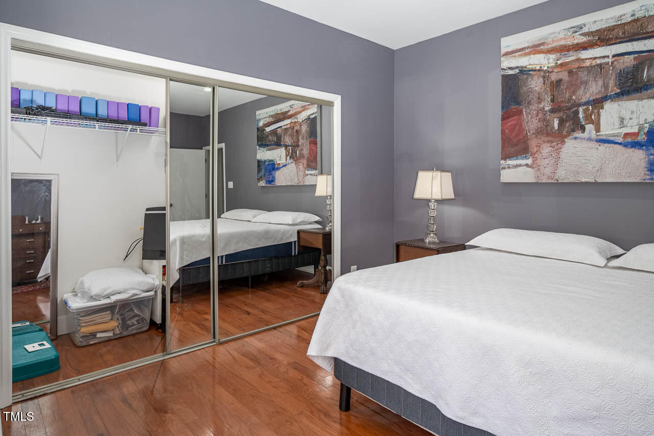 9501 Coachway Chapel Hill, NC 27516 - Photo 22 of 47 a bedroom with a bed and a mirror