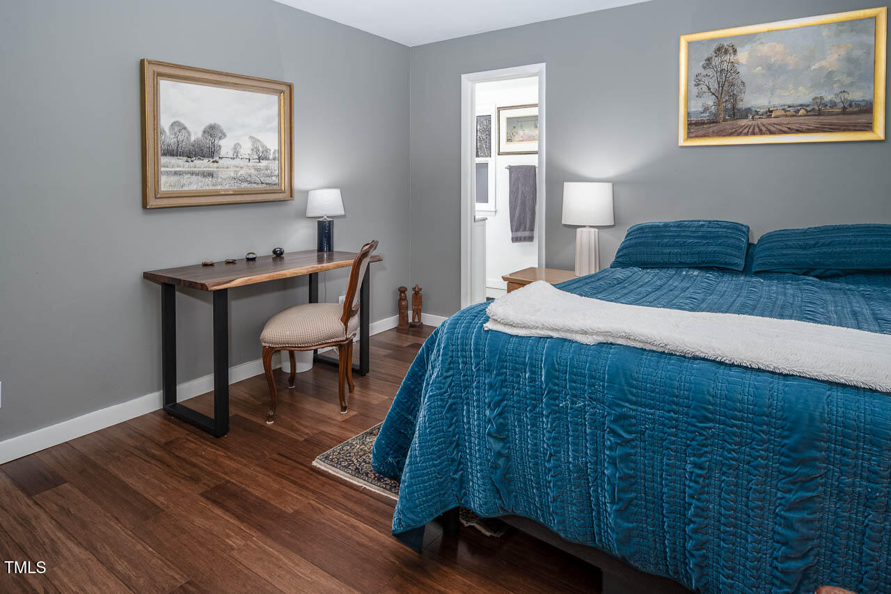 9501 Coachway Chapel Hill, NC 27516 - Photo 29 of 47 a bedroom with a bed and a table in it