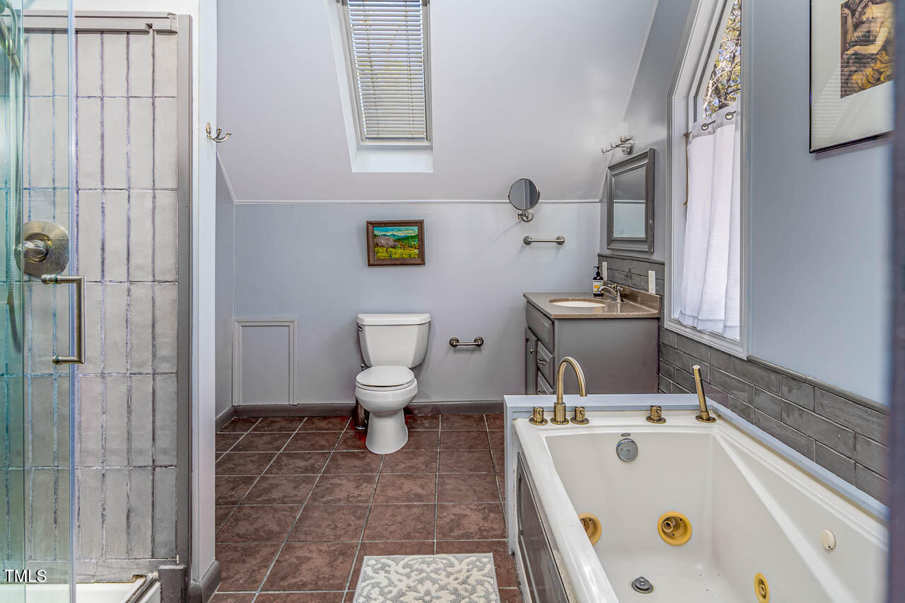 9501 Coachway Chapel Hill, NC 27516 - Photo 32 of 47 a bathroom with a sink a toilet and shower