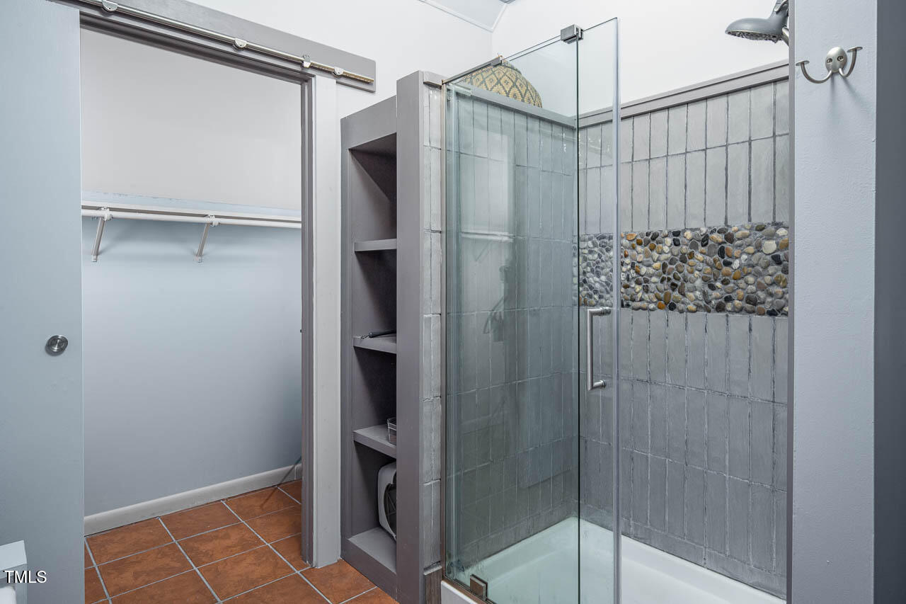 9501 Coachway Chapel Hill, NC 27516 - Photo 33 of 47 a bathroom with a shower and a glass door