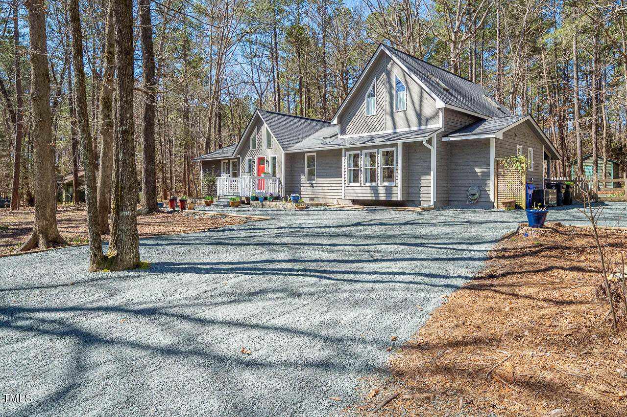 9501 Coachway Chapel Hill, NC 27516 - Photo 35 of 47 a view of a house with a small yard and large trees