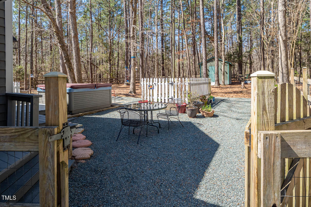 9501 Coachway Chapel Hill, NC 27516 - Photo 36 of 47 a living room with chairs and a fireplace with wooden floor