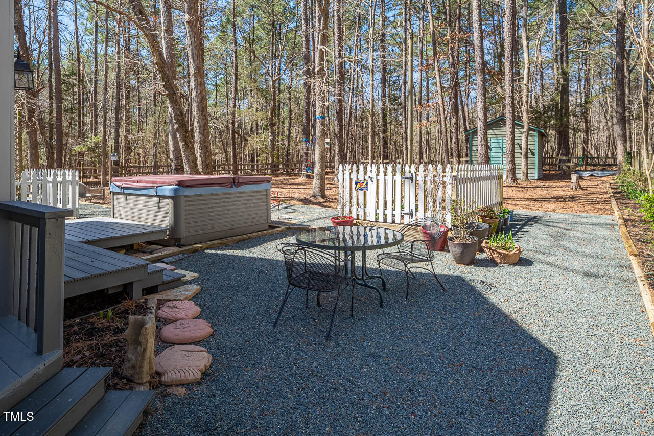 9501 Coachway Chapel Hill, NC 27516 - Photo 38 of 47 a roof deck with table and chairs and potted plants