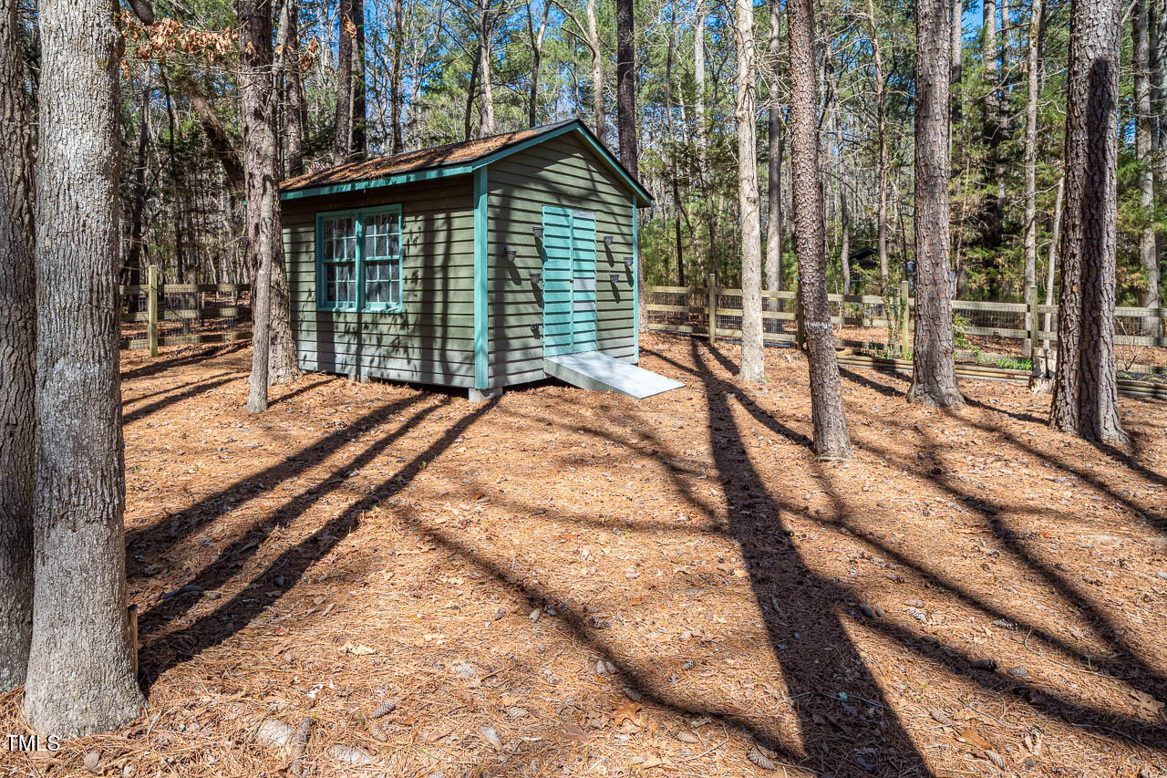 9501 Coachway Chapel Hill, NC 27516 - Photo 41 of 47 a view of backyard with large trees and wooden fence