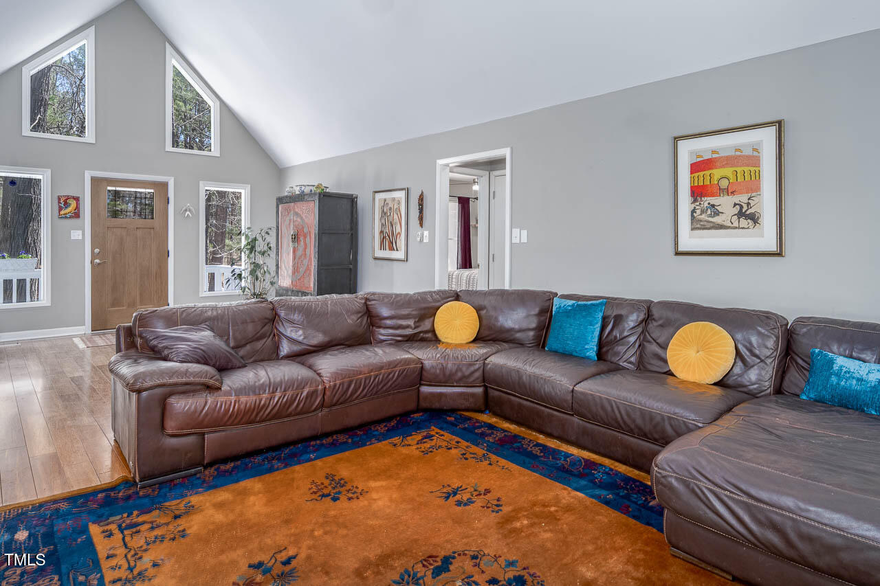 9501 Coachway Chapel Hill, NC 27516 - Photo 7 of 47 a living room with furniture ceiling fan and a rug