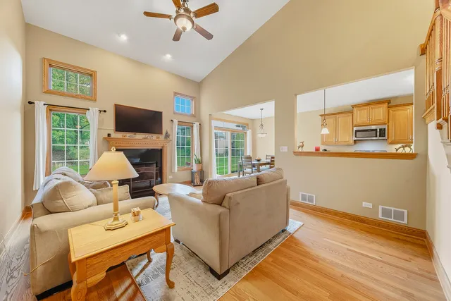 a living room with furniture a flat screen tv and a large window