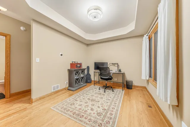 a view of a workspace with furniture and a window