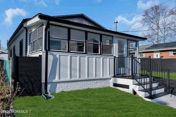 a view of a house with a yard and deck