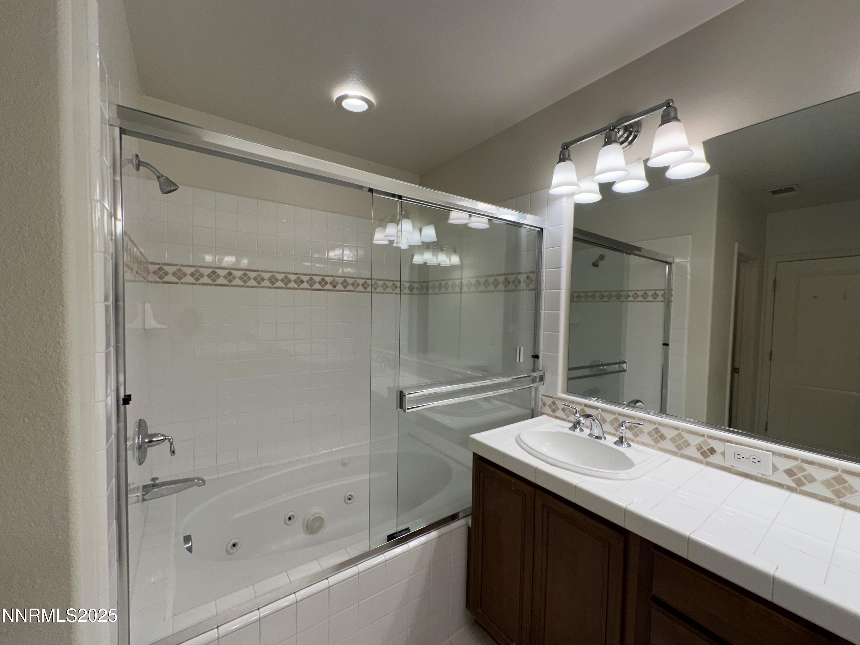 1625 Clover Hill Trail Reno, NV 89523 - Photo 21 of 41 a bathroom with a bath tub sink and mirror