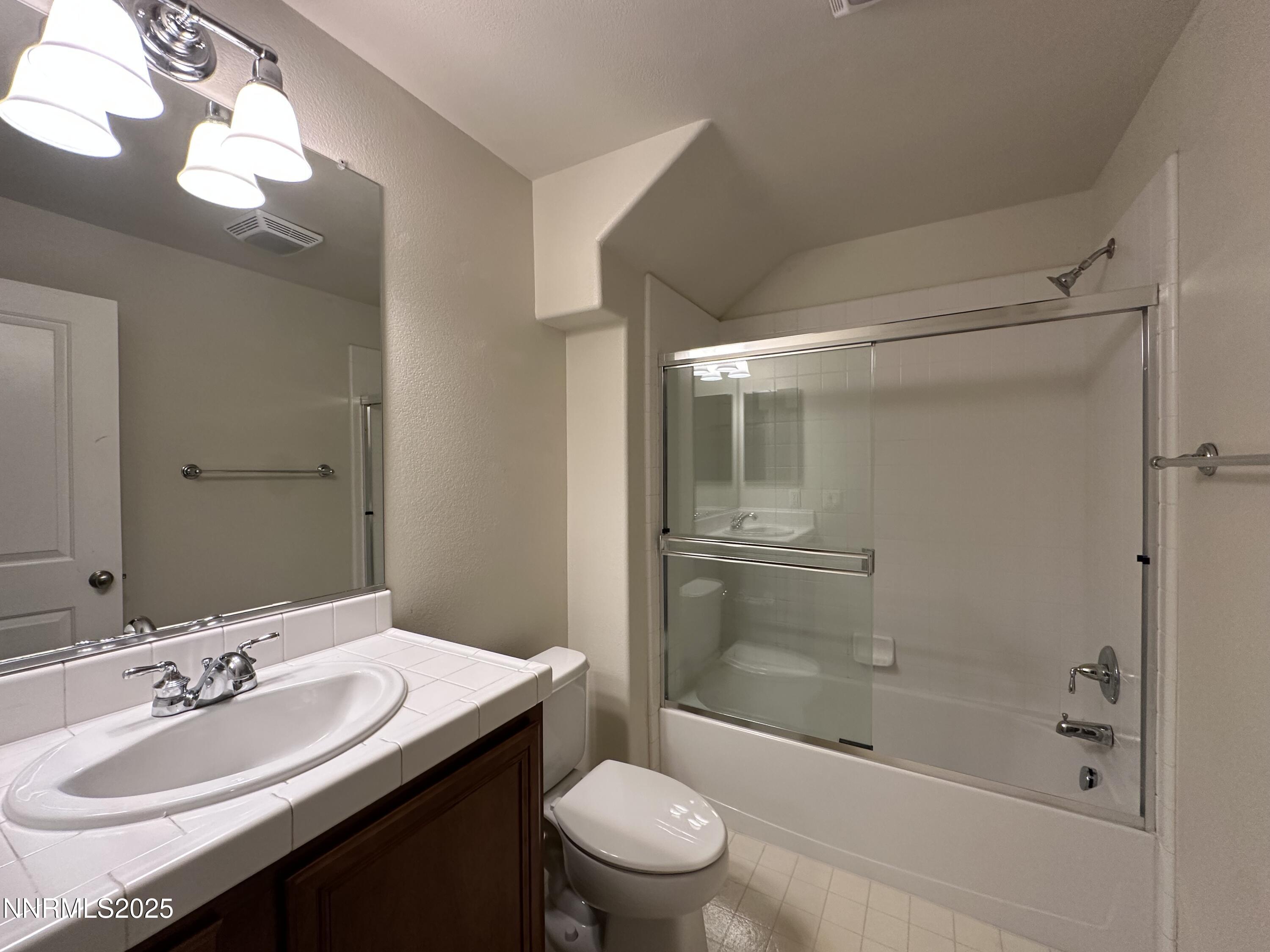 1625 Clover Hill Trail Reno, NV 89523 - Photo 27 of 41 a bathroom with a sink a toilet and shower