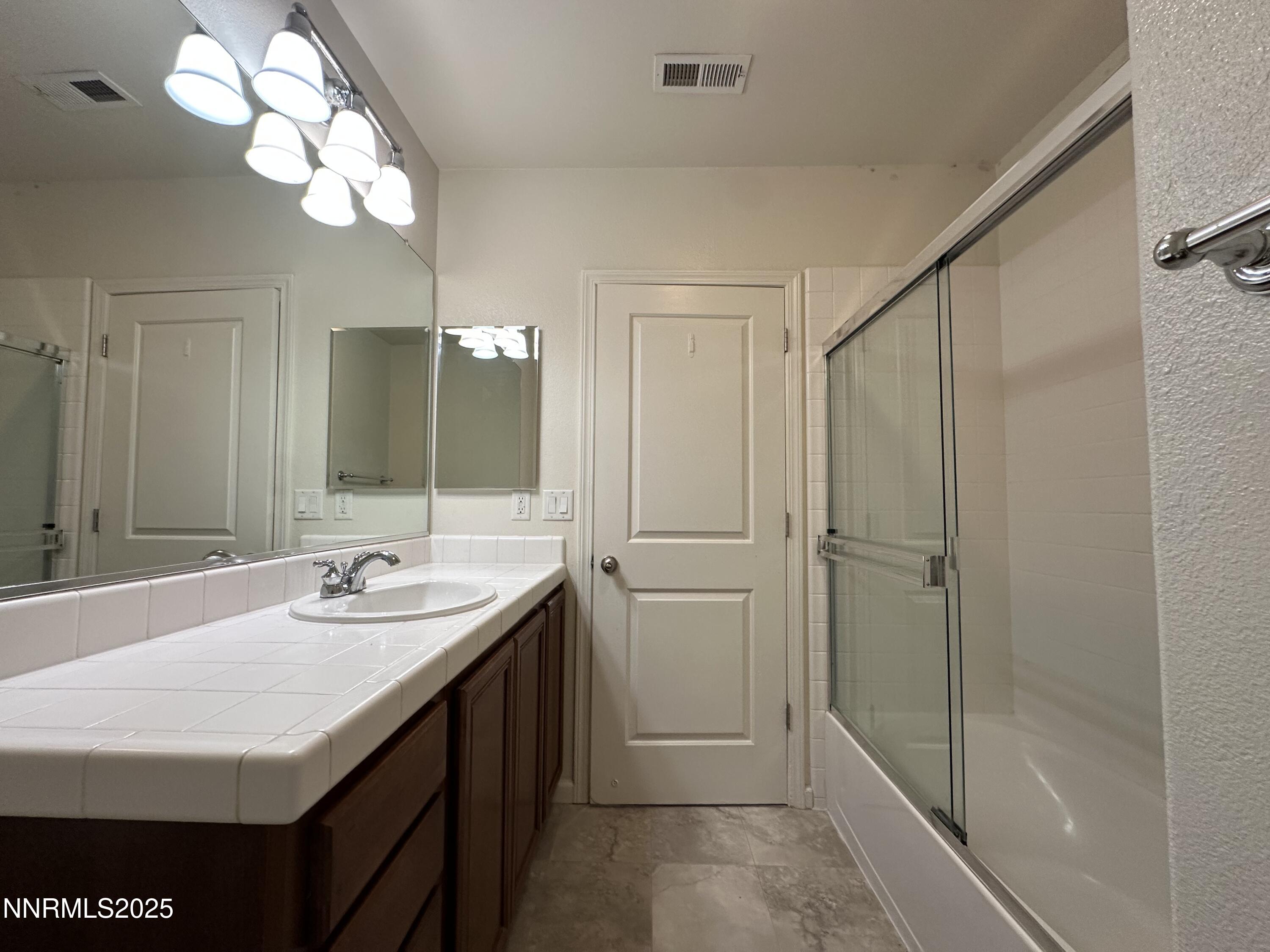 1625 Clover Hill Trail Reno, NV 89523 - Photo 32 of 41 a bathroom with a sink a mirror and a shower