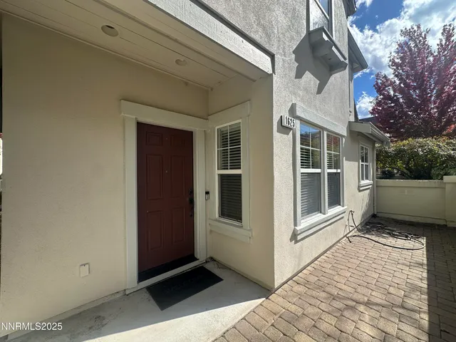 a view of a house with a door and wooden floor