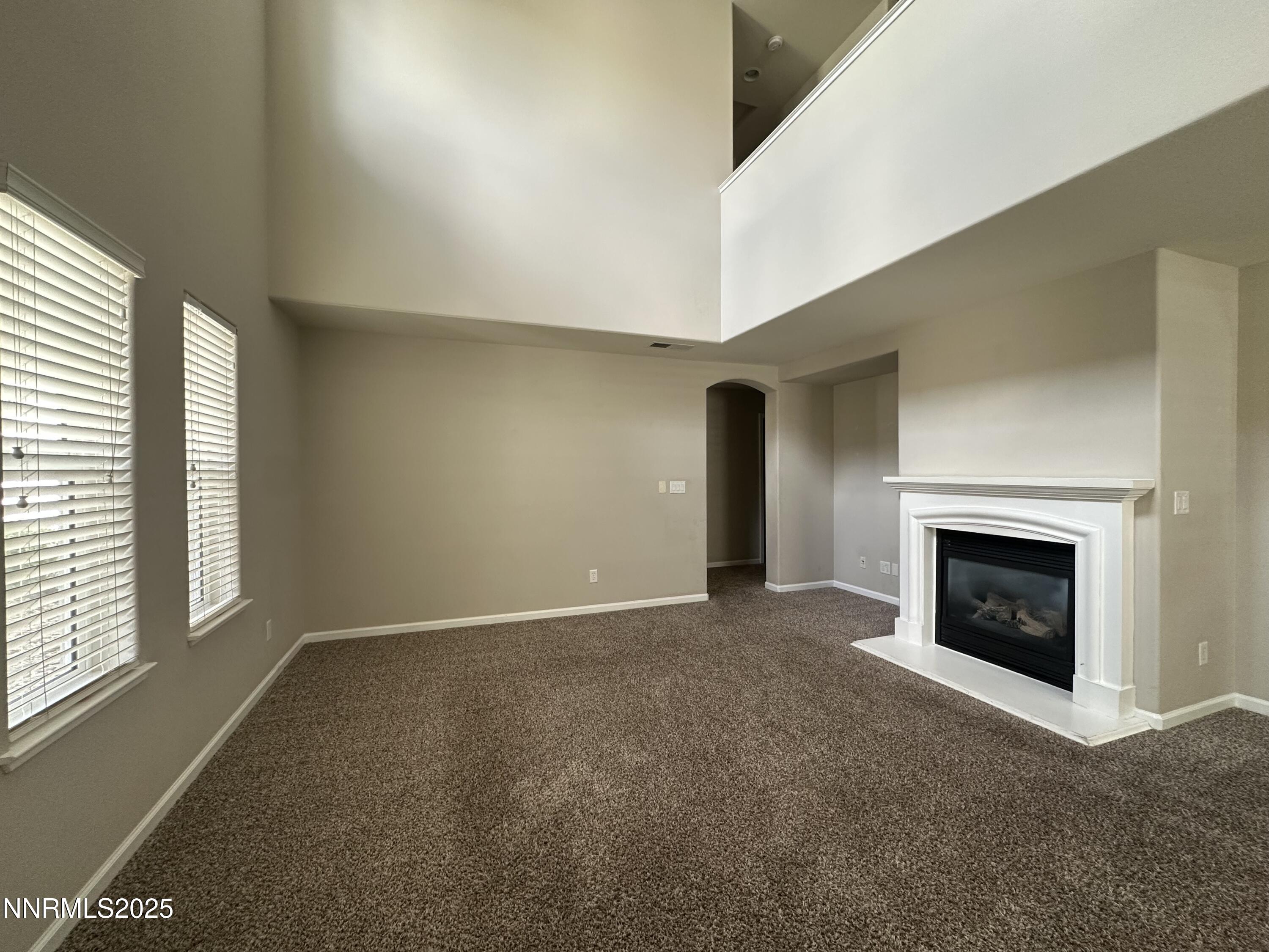 1625 Clover Hill Trail Reno, NV 89523 - Photo 9 of 41 a view of an empty room with a window and fireplace