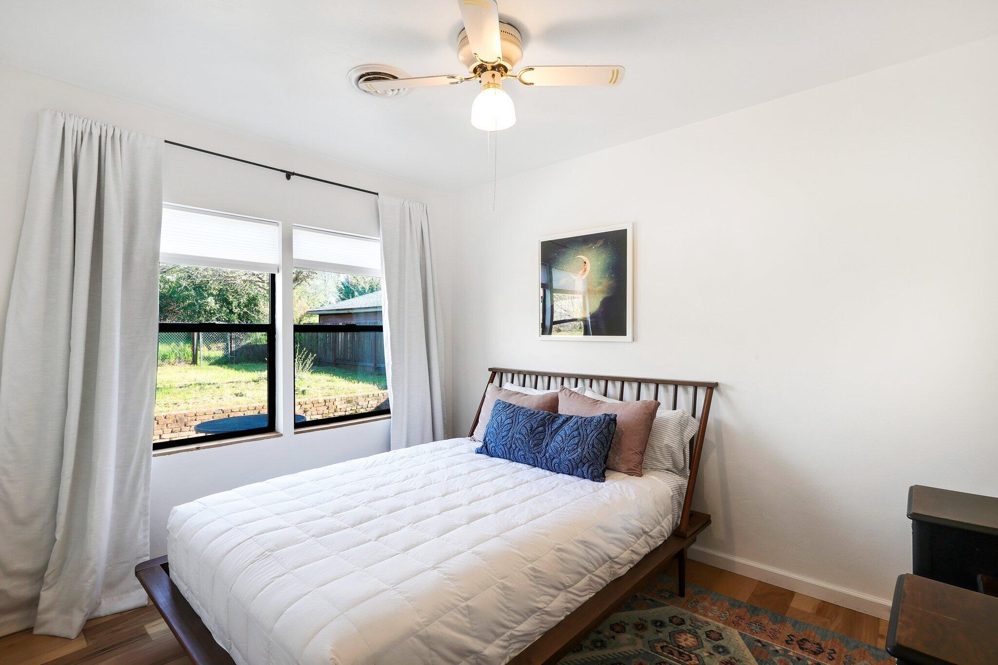 1750 Barbara Road Redding, CA 96003 - Photo 11 of 21 a bedroom with a large bed and a window