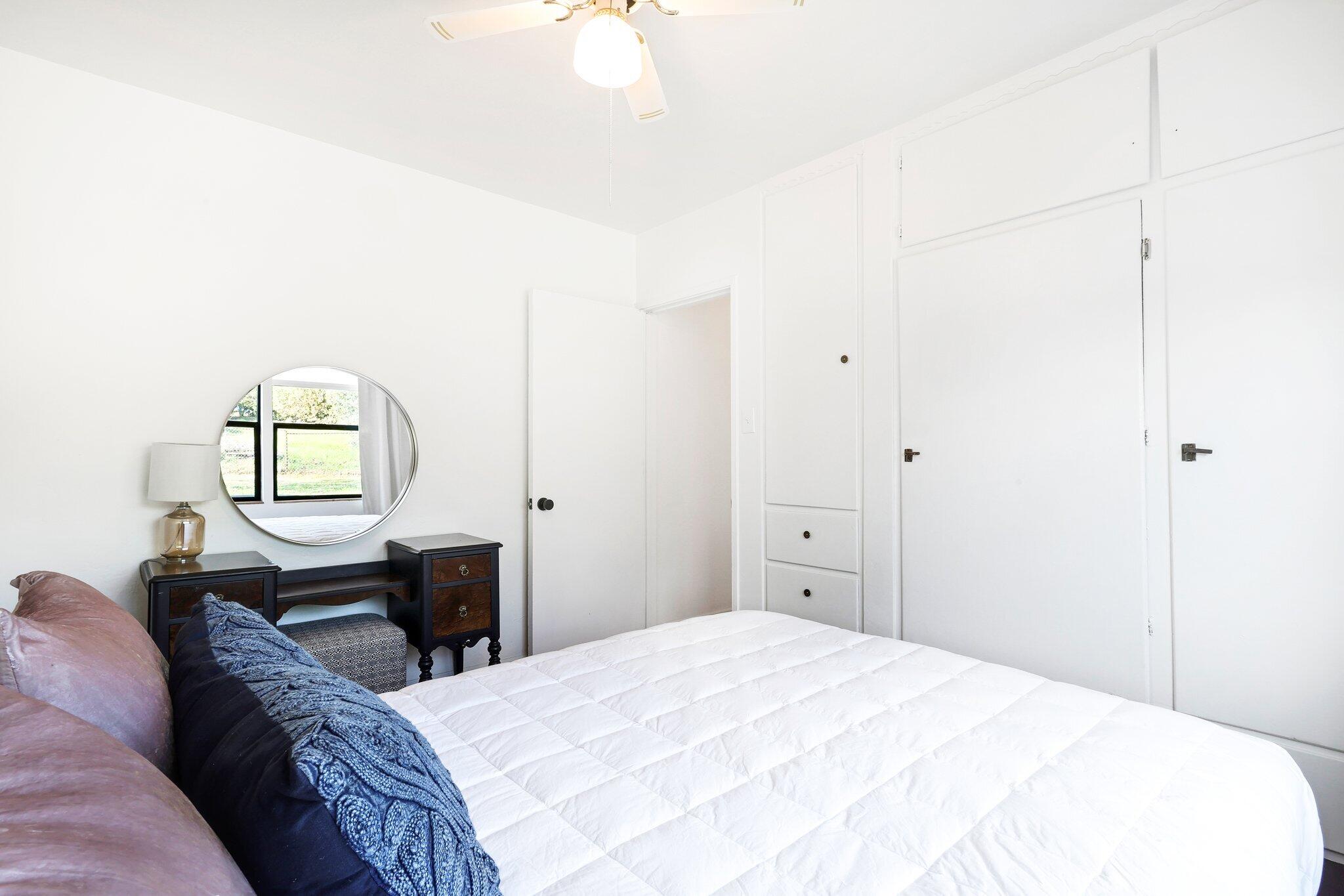 1750 Barbara Road Redding, CA 96003 - Photo 12 of 21 a bedroom with a bed and a dresser with mirror