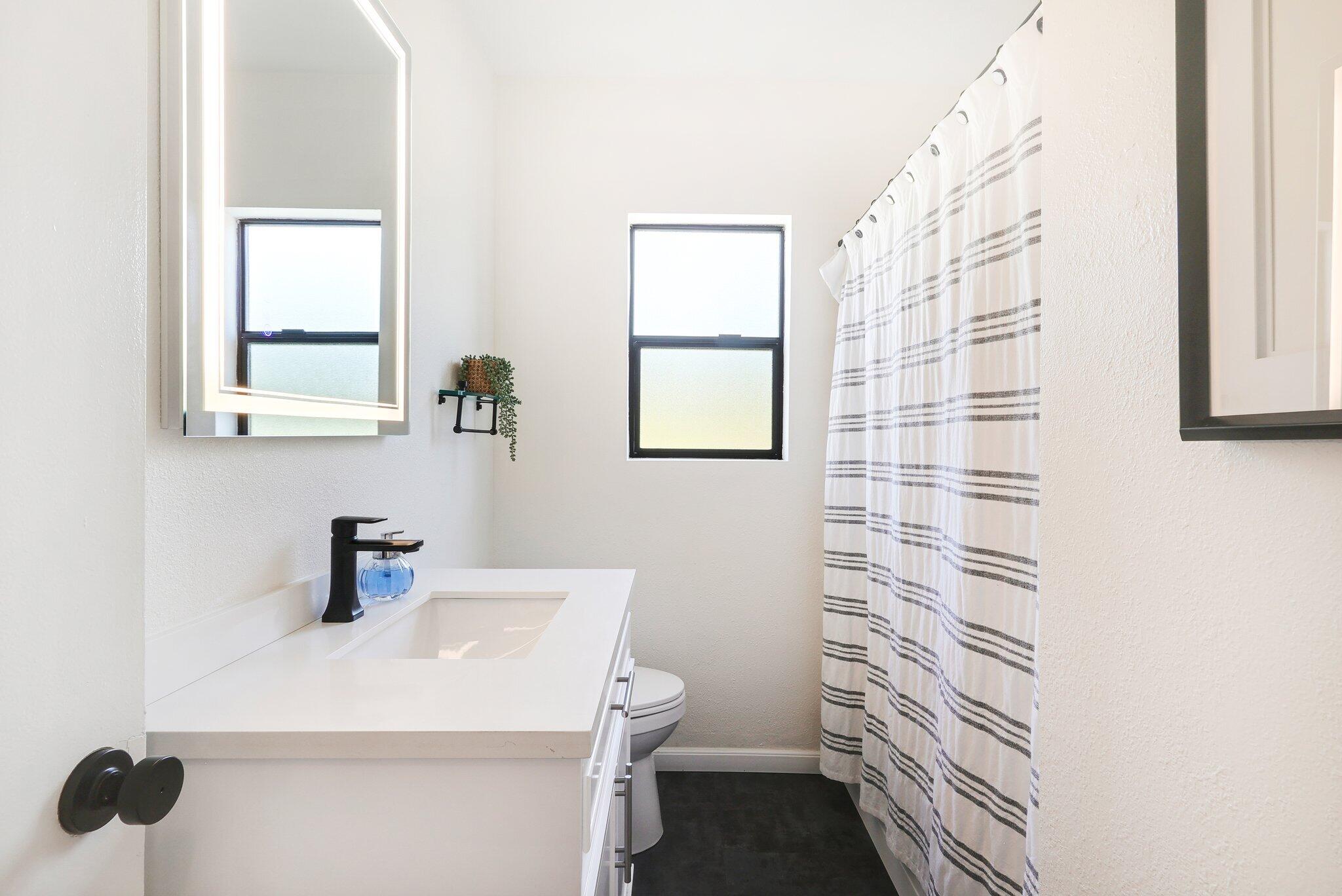 1750 Barbara Road Redding, CA 96003 - Photo 13 of 21 a bathroom with a sink a toilet and mirror