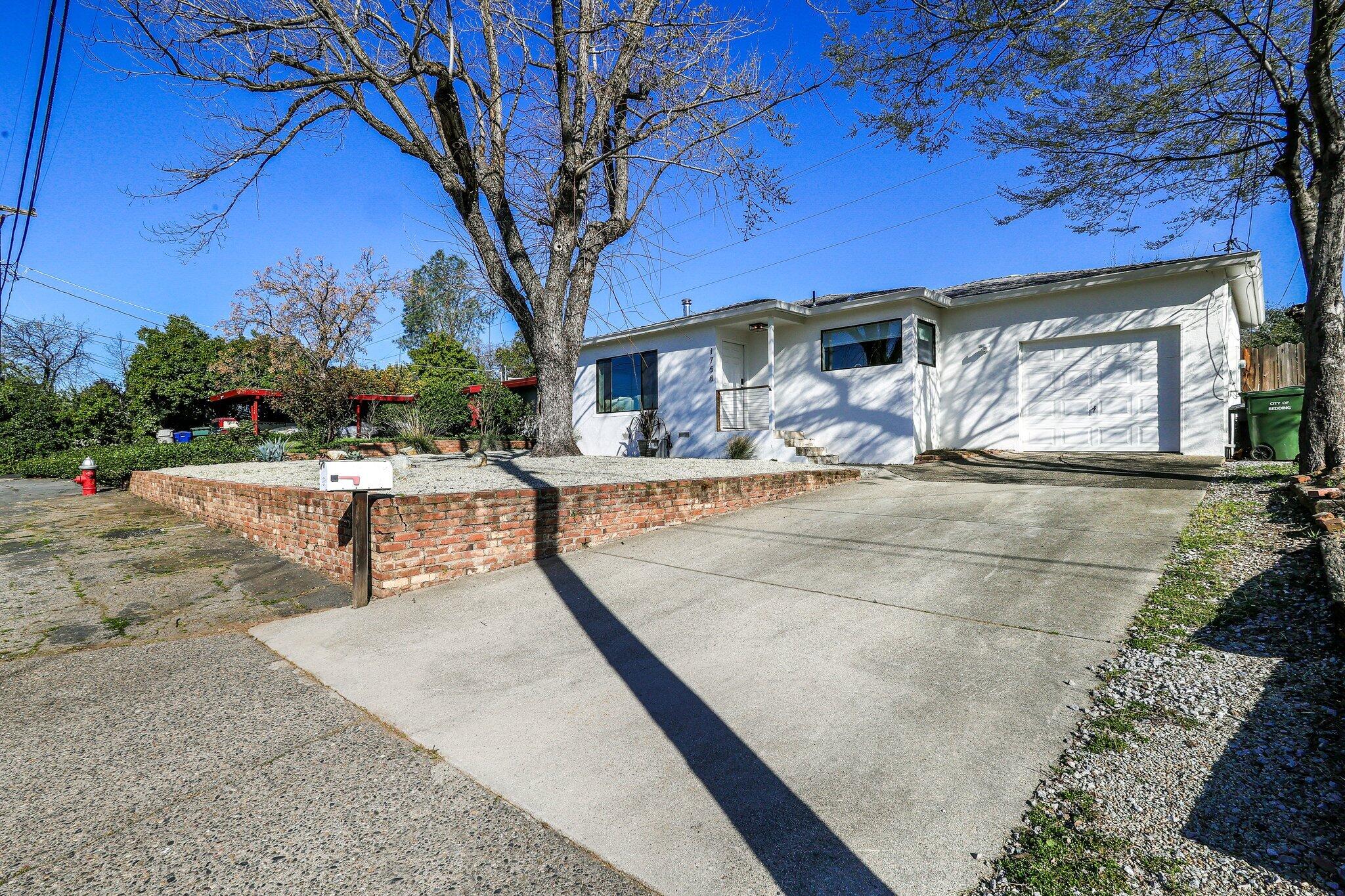 1750 Barbara Road Redding, CA 96003 - Photo 2 of 21 a view of a house with backyard and sitting area