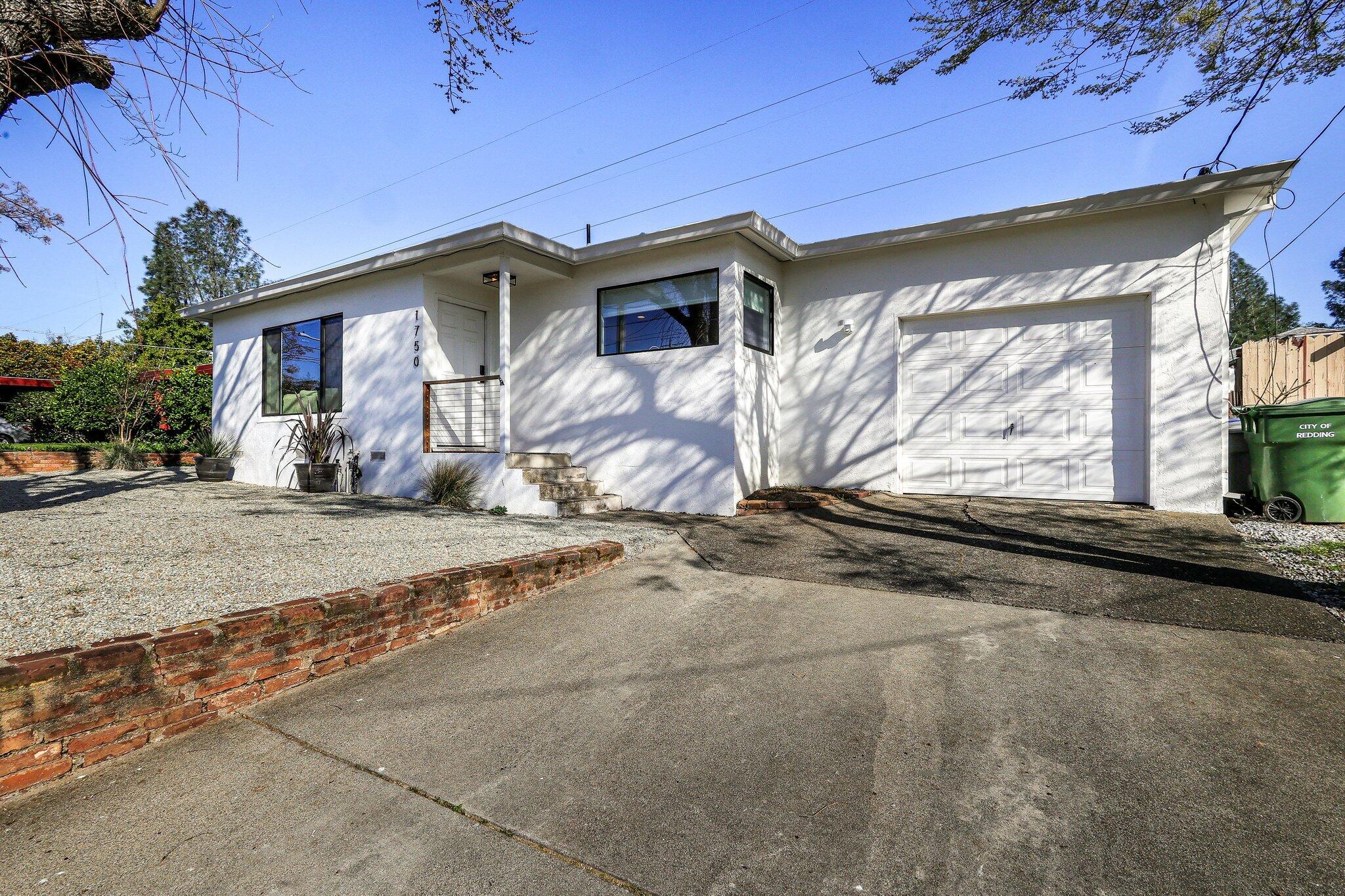 1750 Barbara Road Redding, CA 96003 - Photo 3 of 21 a front view of a house with a yard