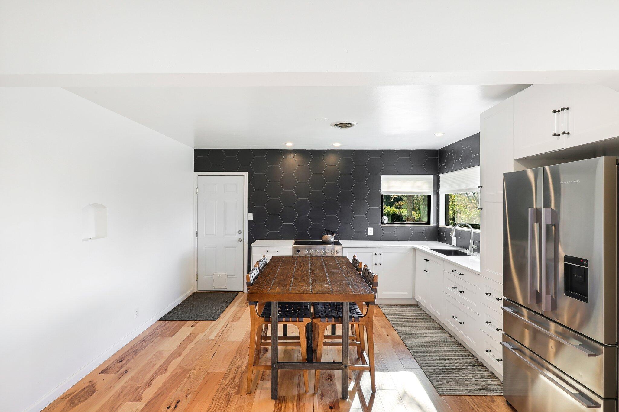 1750 Barbara Road Redding, CA 96003 - Photo 6 of 21 a kitchen with stainless steel appliances a stove a refrigerator and cabinets