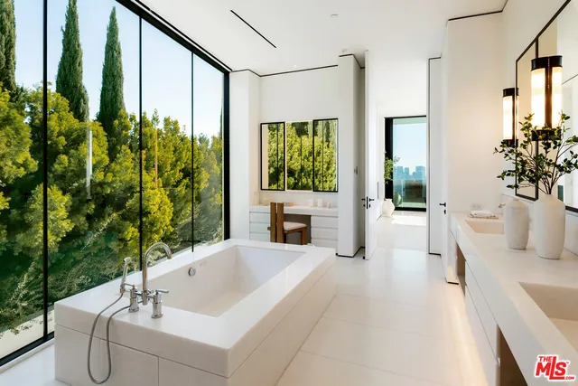 a spacious bathroom with a tub sink and shower