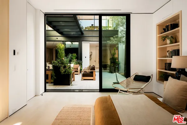 a bedroom with double bed and a large window