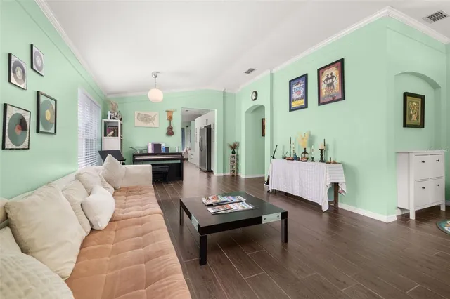 a kitchen with stainless steel appliances kitchen island granite countertop a table chairs and a refrigerator