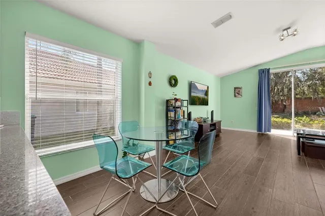 a view of a workspace with furniture and a ceiling fan