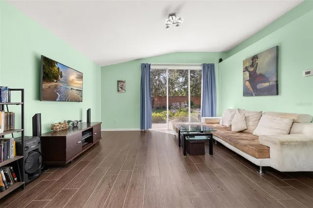 an aerial view of a house with a garden and lake view