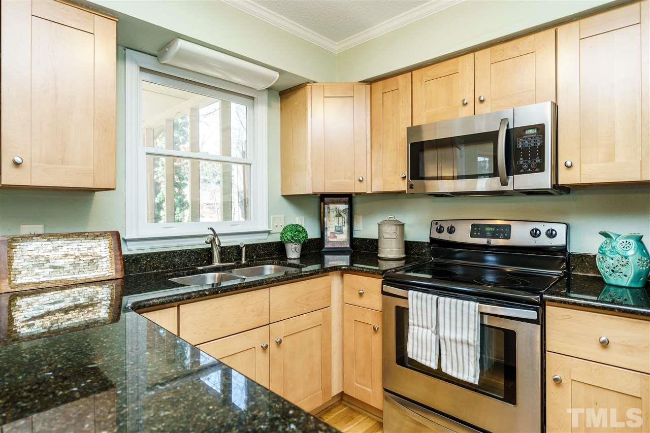 5532 Hamstead Crossing Raleigh, NC 27612 - Photo 11 of 25 a kitchen with stainless steel appliances granite countertop a sink a stove a microwave and cabinets