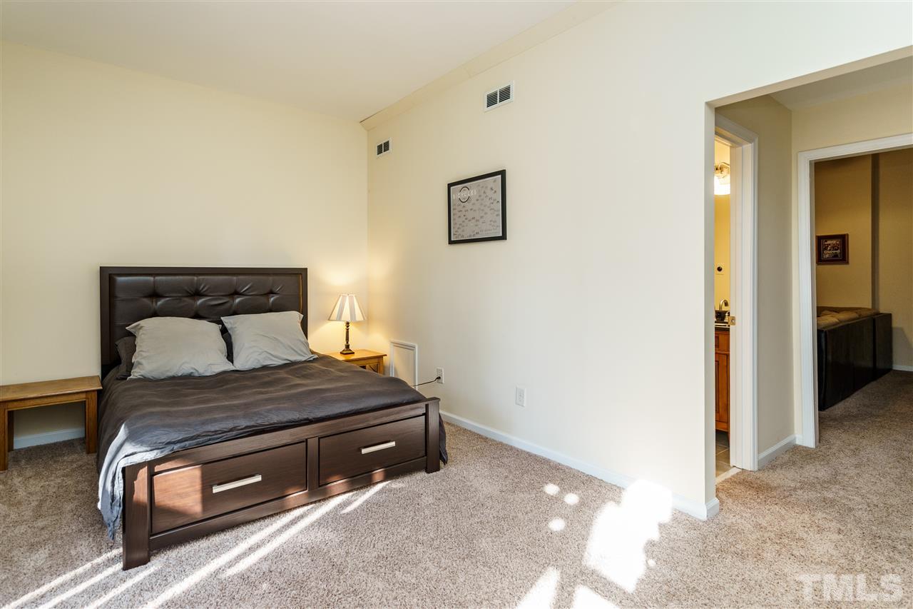 5532 Hamstead Crossing Raleigh, NC 27612 - Photo 19 of 25 a bedroom with a bed and a view of bathroom