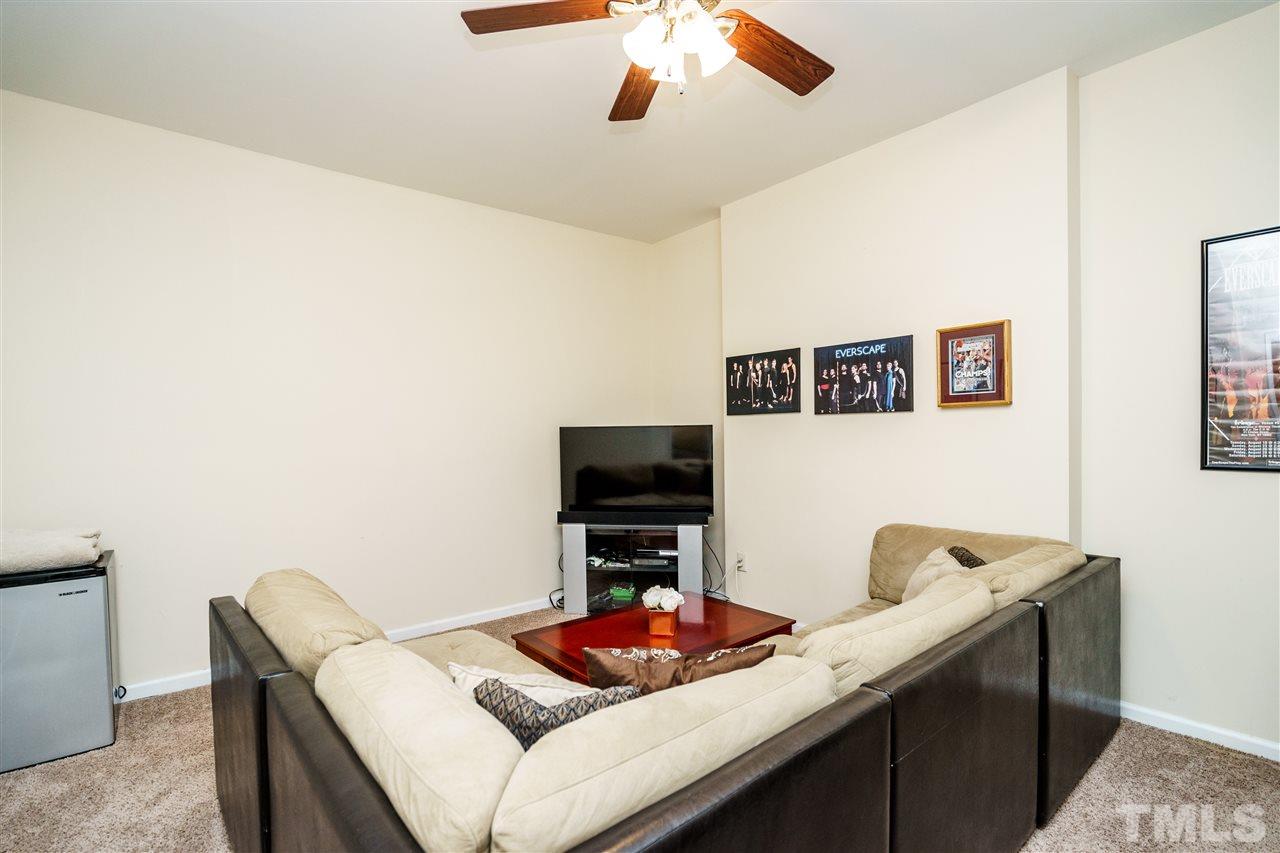5532 Hamstead Crossing Raleigh, NC 27612 - Photo 21 of 25 a living room with furniture and a flat screen tv