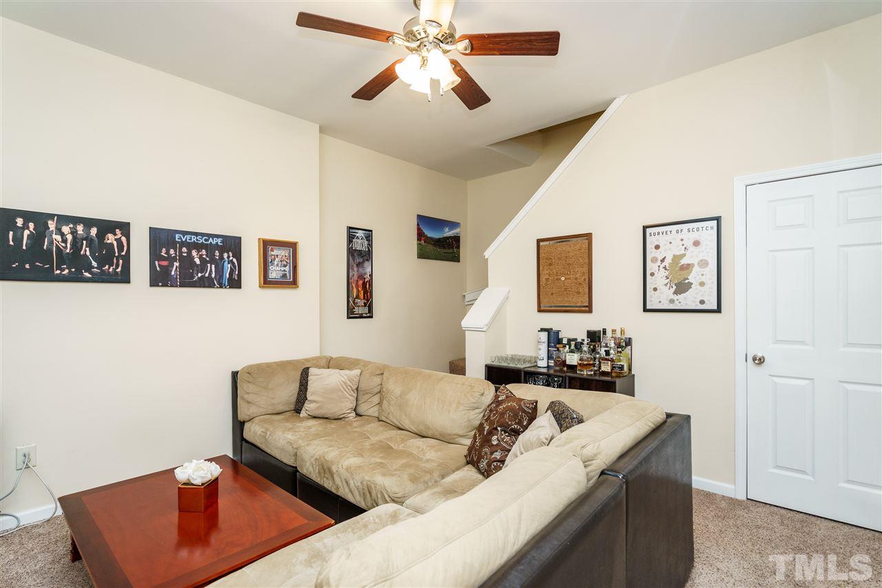 5532 Hamstead Crossing Raleigh, NC 27612 - Photo 22 of 25 a living room with furniture and a flat screen tv