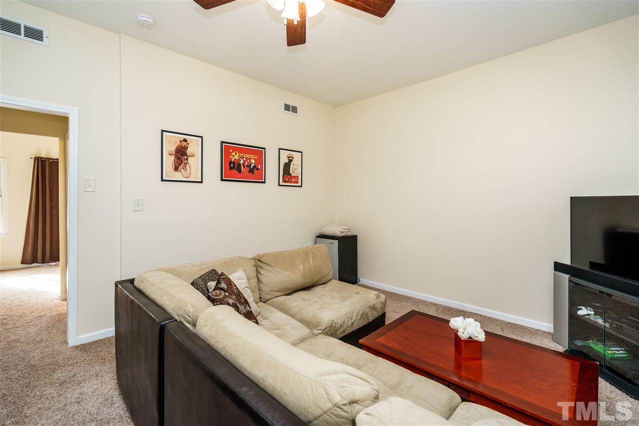 5532 Hamstead Crossing Raleigh, NC 27612 - Photo 23 of 25 a living room with furniture and a flat screen tv
