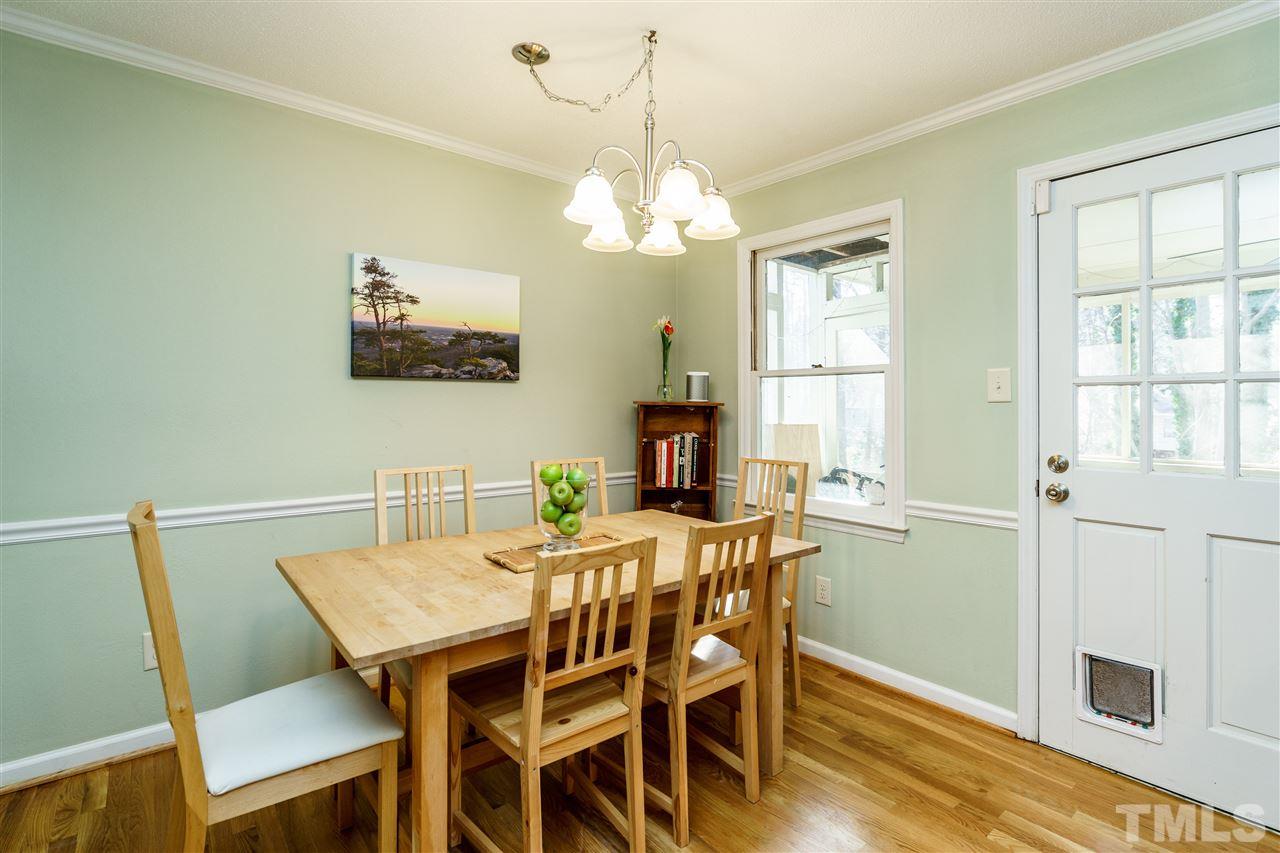 5532 Hamstead Crossing Raleigh, NC 27612 - Photo 7 of 25 a view of a dining room with furniture a chandelier and wooden floor
