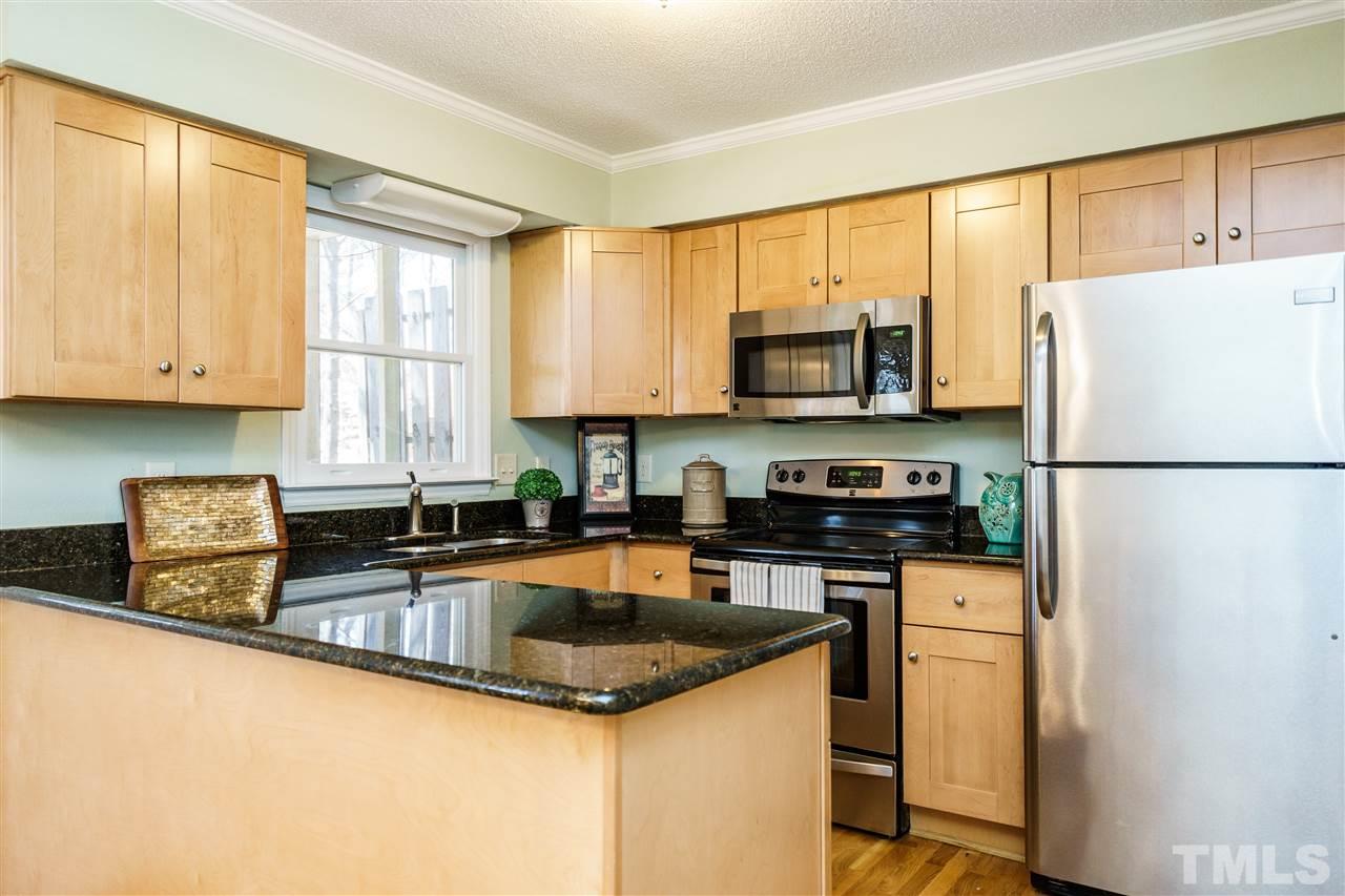 5532 Hamstead Crossing Raleigh, NC 27612 - Photo 8 of 25 a kitchen with granite countertop a refrigerator stove top oven and sink