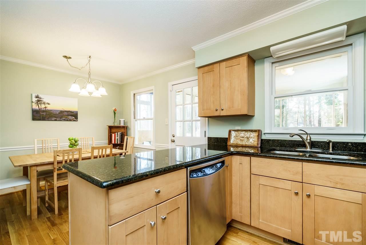 5532 Hamstead Crossing Raleigh, NC 27612 - Photo 9 of 25 a kitchen with granite countertop a sink and cabinets