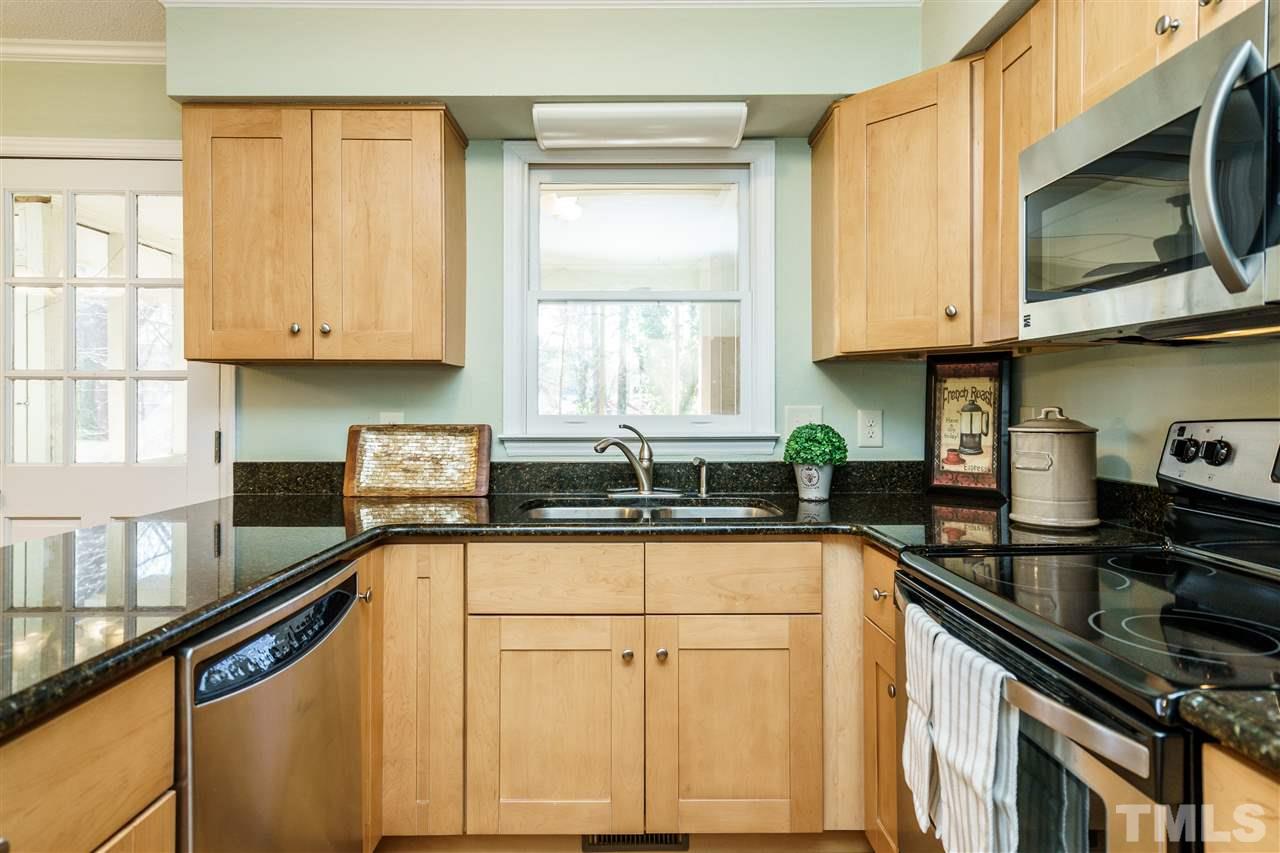 5532 Hamstead Crossing Raleigh, NC 27612 - Photo 10 of 25 a kitchen with a sink stove top oven and cabinets