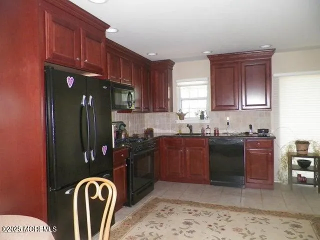 a kitchen with stainless steel appliances granite countertop a stove refrigerator and cabinets