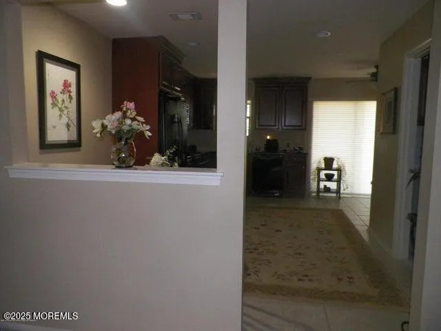 a view of a hallway to a livingroom and a dinning room with furniture