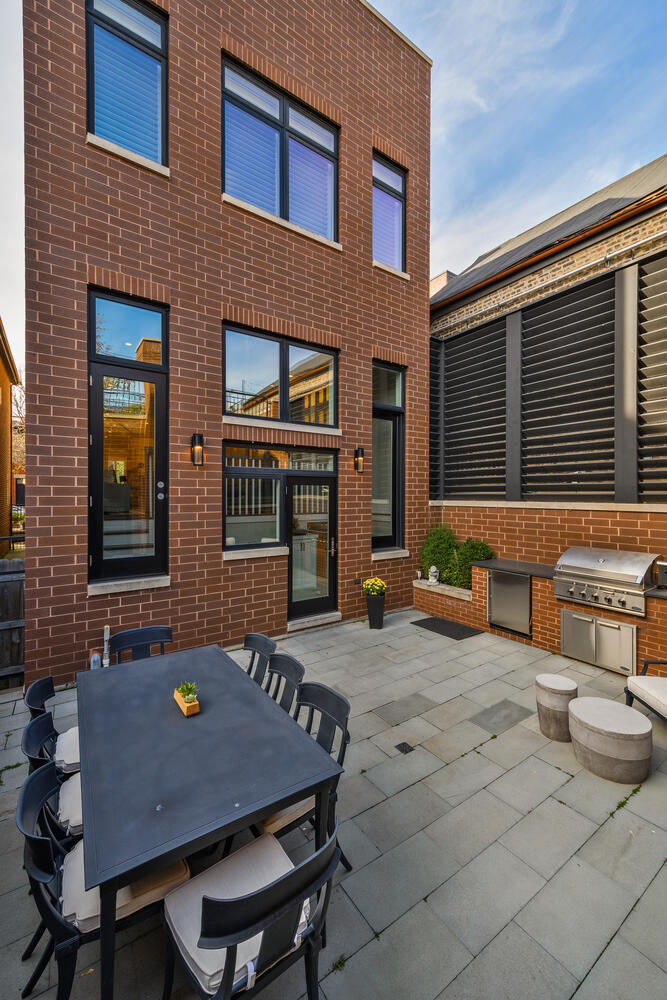 1823 North Bissell Street Chicago, IL 60614 - Photo 56 of 56 a backyard of a house with barbeque oven table and chairs
