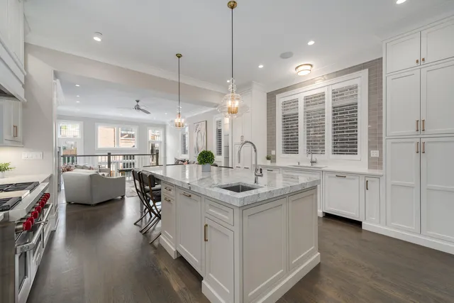 a kitchen with a stove and white cabinets