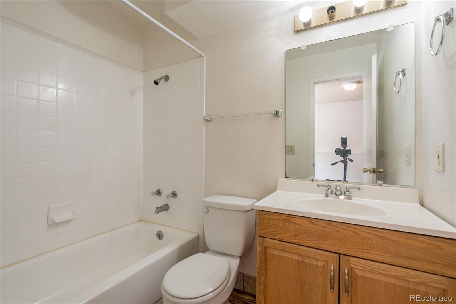720 City Park Avenue, Unit C310 Fort Collins, CO 80521 - Photo 13 of 17 a bathroom with a sink a toilet and shower