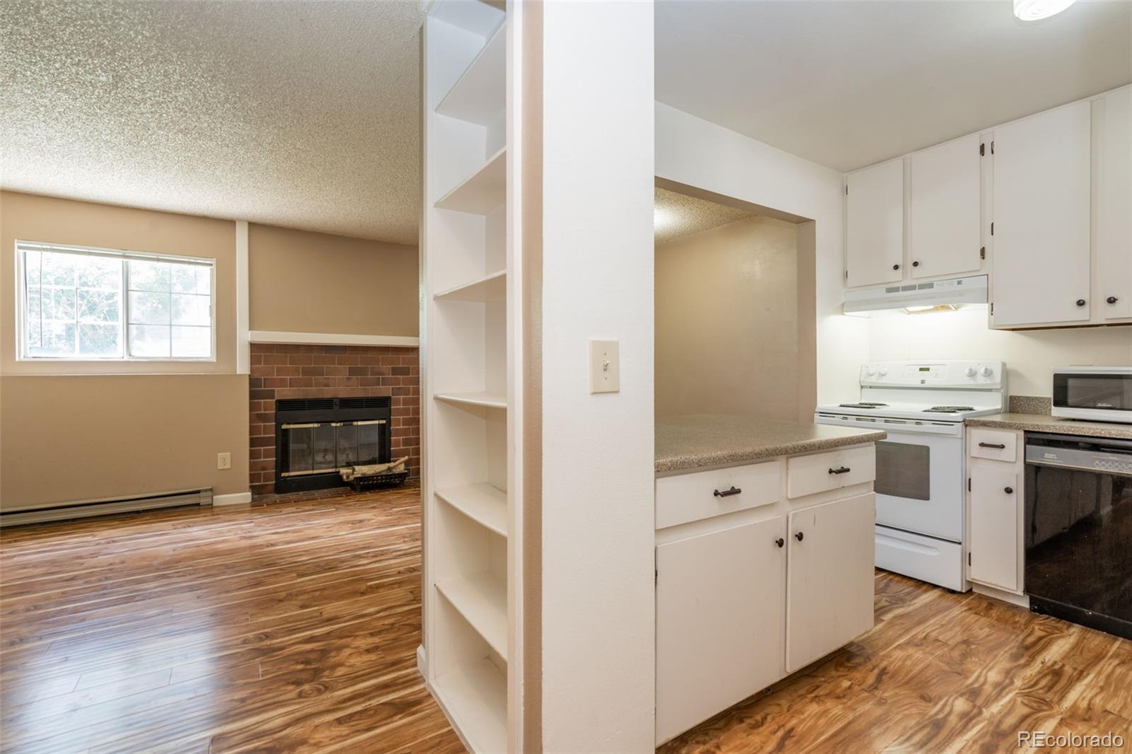 720 City Park Avenue, Unit C310 Fort Collins, CO 80521 - Photo 15 of 17 a kitchen with granite countertop a stove and a refrigerator