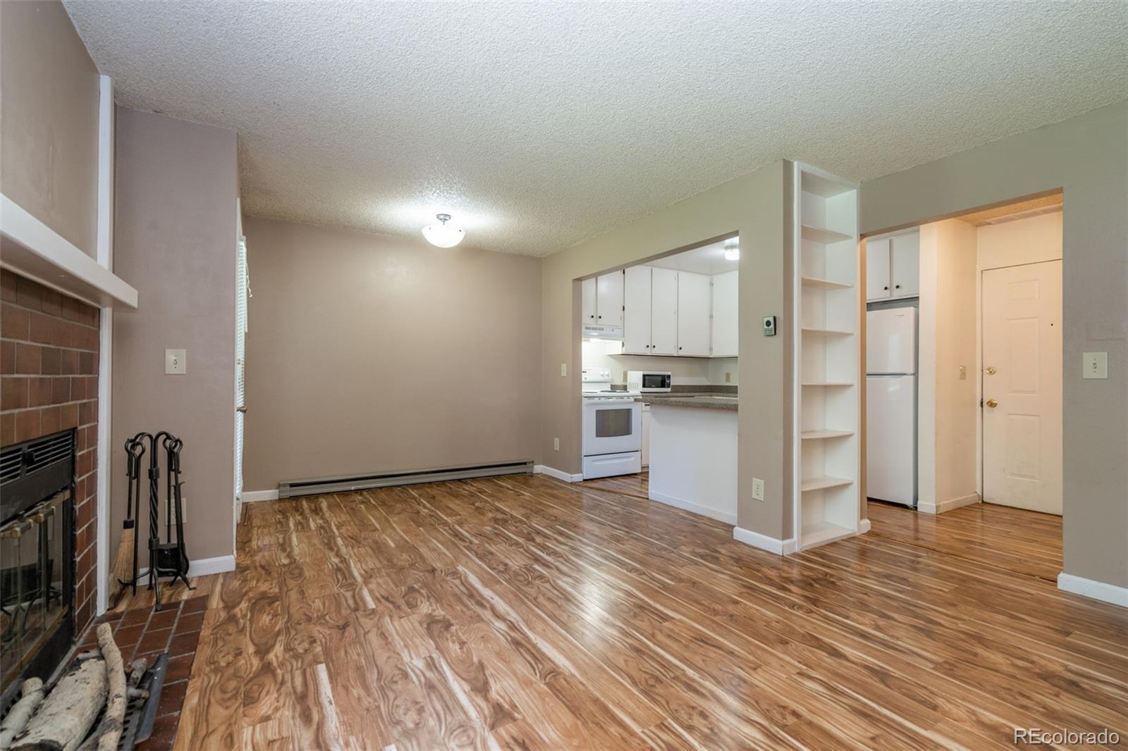720 City Park Avenue, Unit C310 Fort Collins, CO 80521 - Photo 3 of 17 a view of a kitchen with wooden floor and electronic appliances