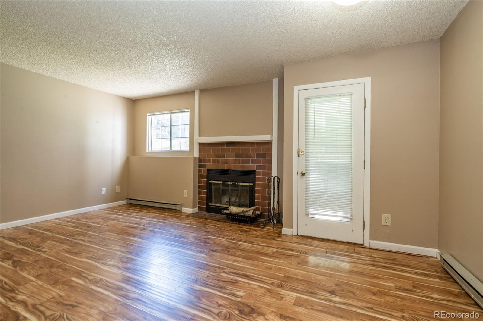 720 City Park Avenue, Unit C310 Fort Collins, CO 80521 - Photo 4 of 17 a view of an empty room with fire place and a window