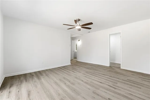 a view of an empty room with wooden floor