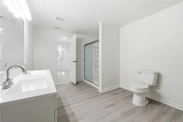 a bathroom with a toilet sink and a mirror