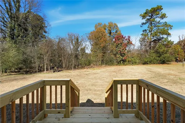 a balcony with wooden floor and fence