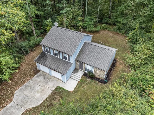 an aerial view of a house having yard patio and backyard