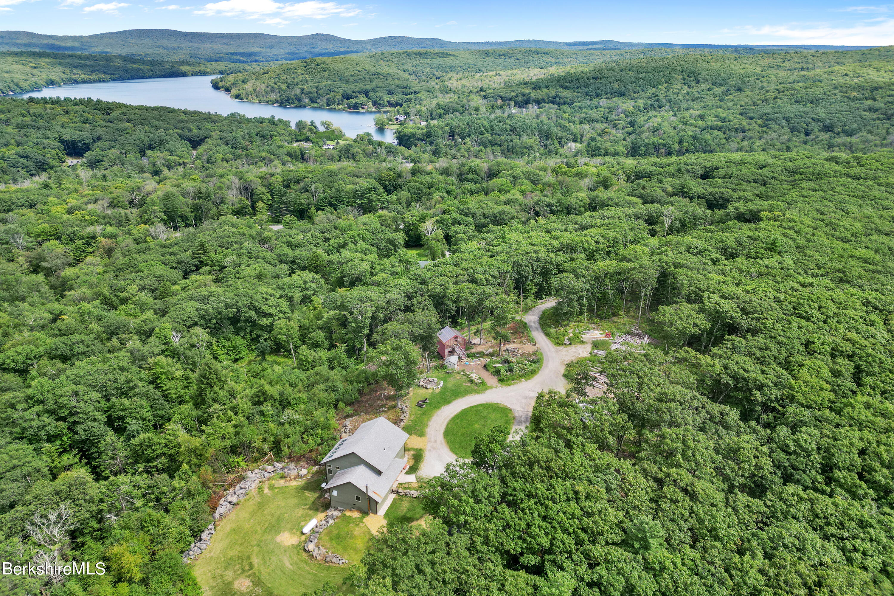 26 A Stonebridge Way Tyringham, MA 01238 - Photo 1 of 74 a view of a forest with a street